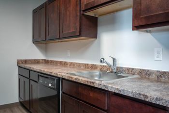 Fully-equipped kitchen with refrigerator, oven/stove, microwave, and dishwasher.